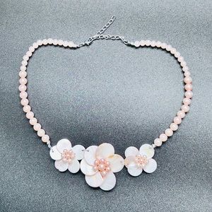 Pink necklace with flowers.